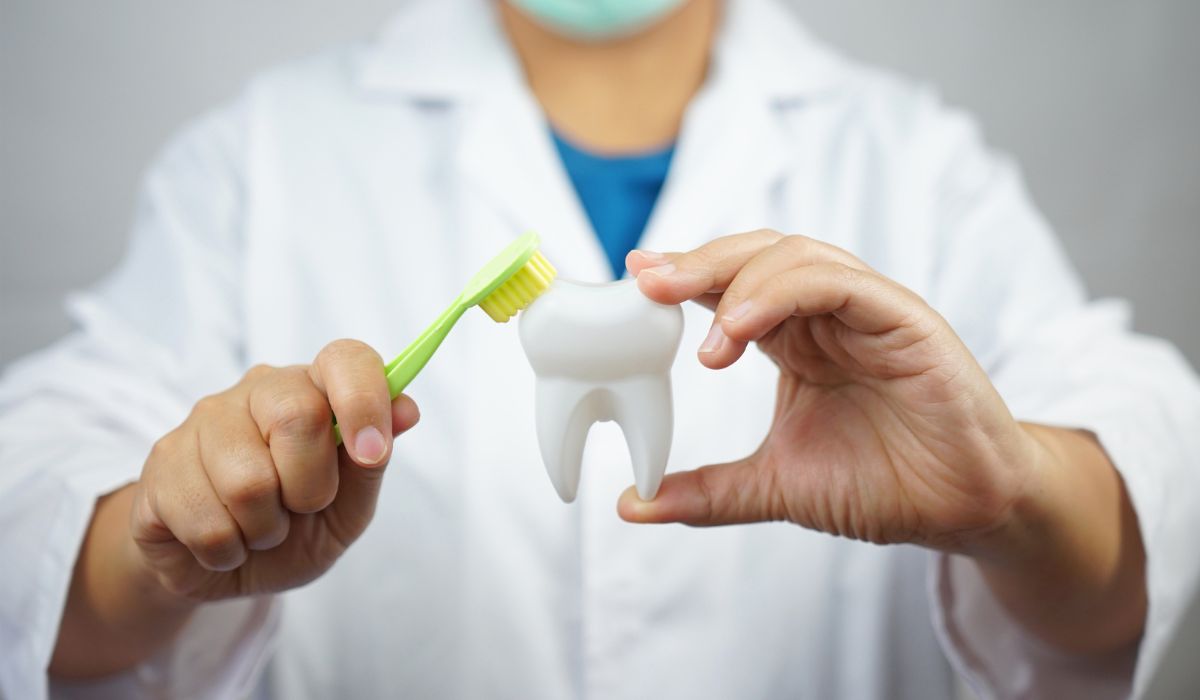 A dentist at work examining a patient’s teeth with precision tools. | JSB Dental Lab