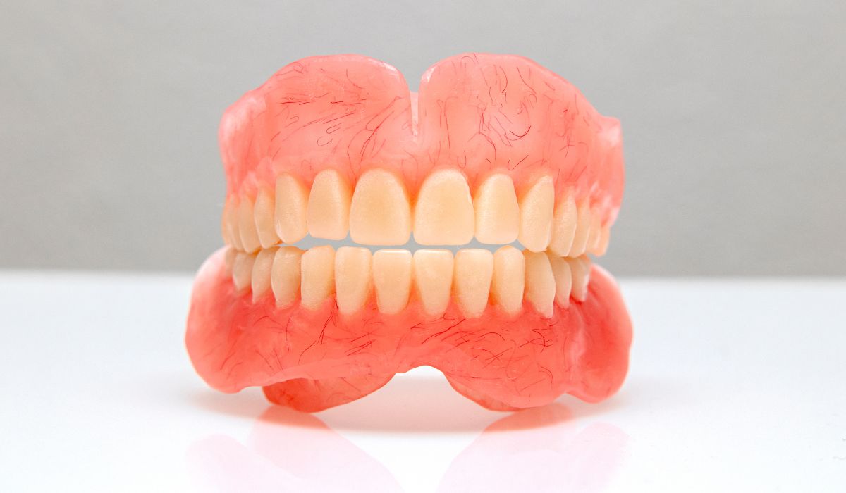 A set of removable dentures displayed on a light background. | JSB Dental Lab